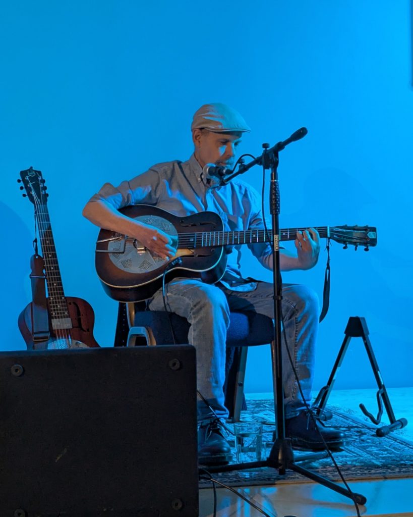 Mark Harrison playing a National resonator guitar
